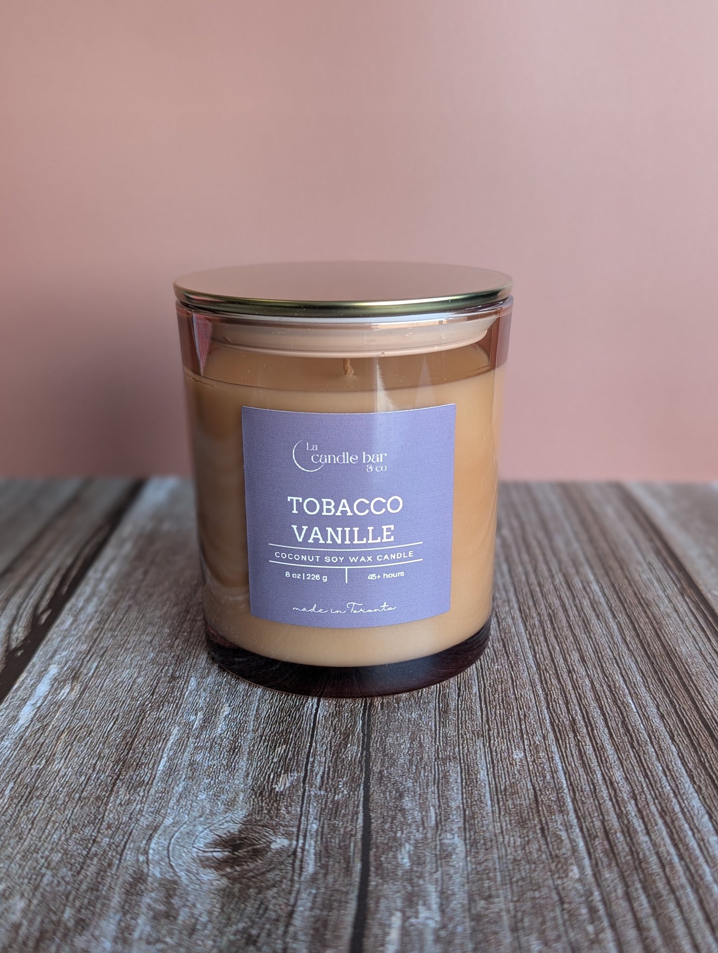 Tobacco Vanille candle with warm vanilla, spices, and tobacco notes in a glass jar