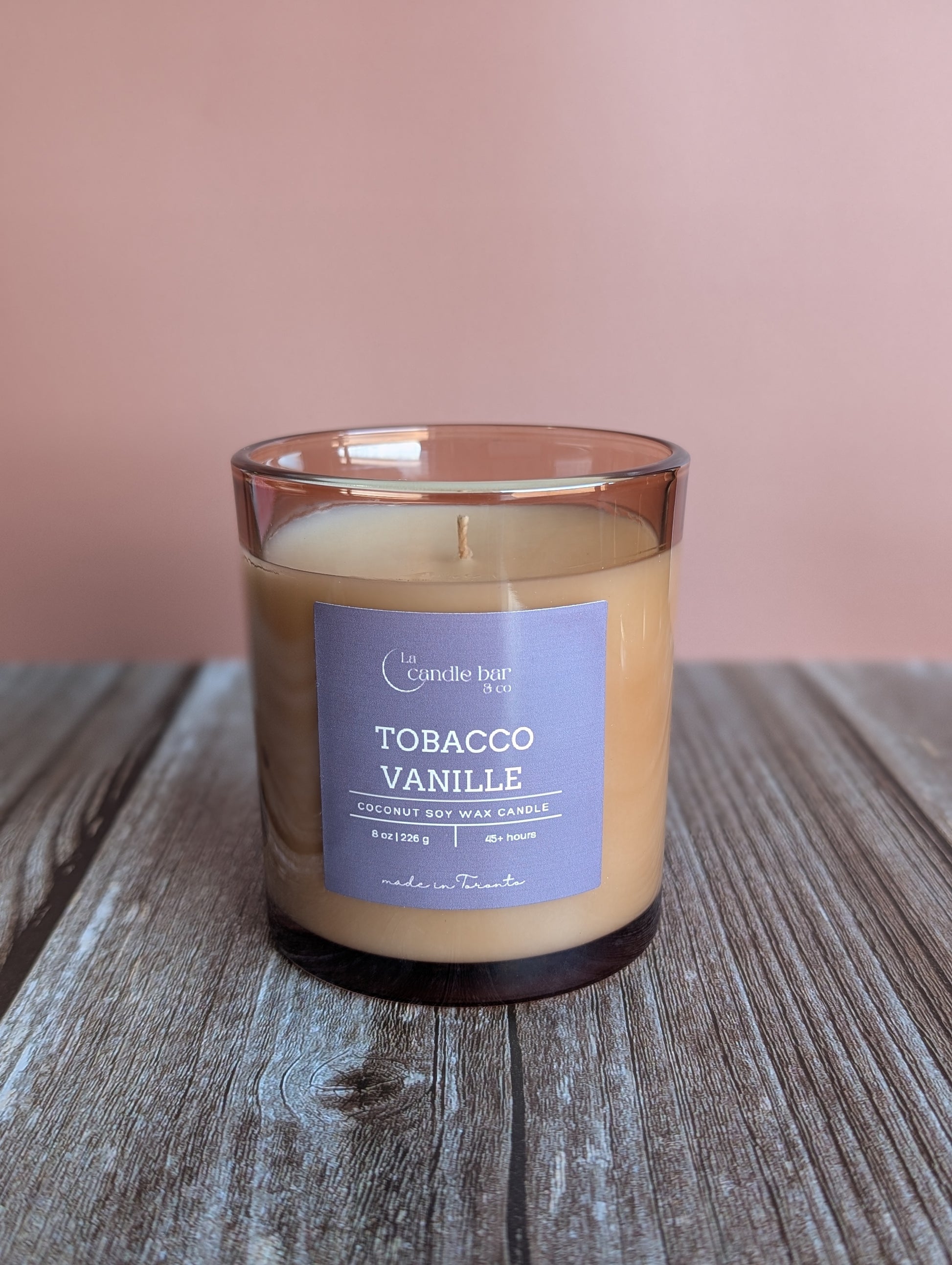 Tobacco Vanille candle with warm vanilla, spices, and tobacco notes in a glass jar